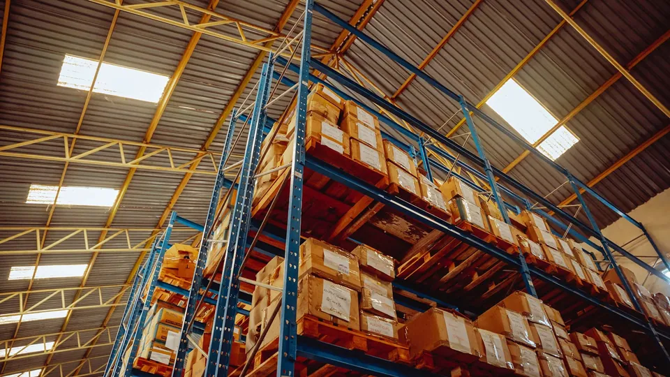 Warehouse shelving stacked high with cardboard boxes