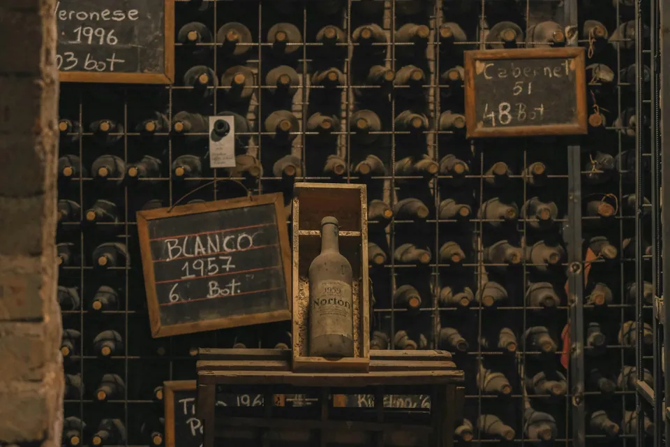 Wine cellar wall of bottles with chalkboard vintage labels