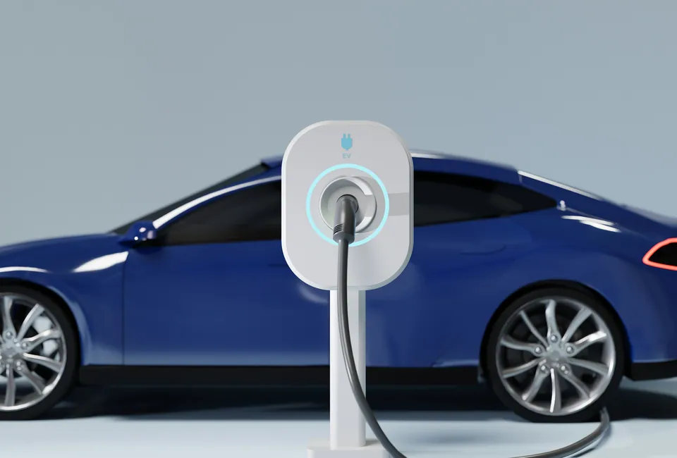 Blue electric car plugged into a wall charger