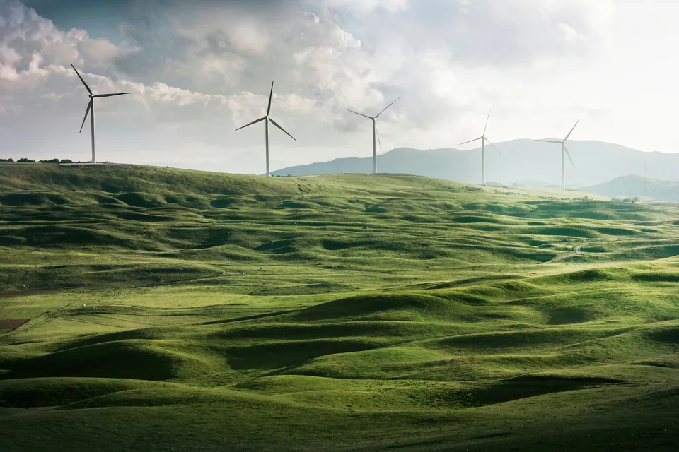 Wind turbines on rolling green hills