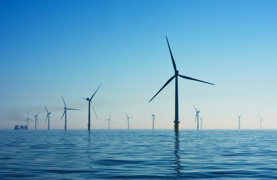 Offshore wind turbines in a calm blue sea