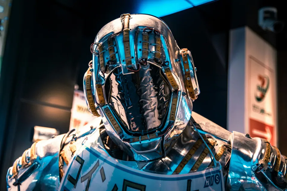 Futuristic chrome robot figure in a city street