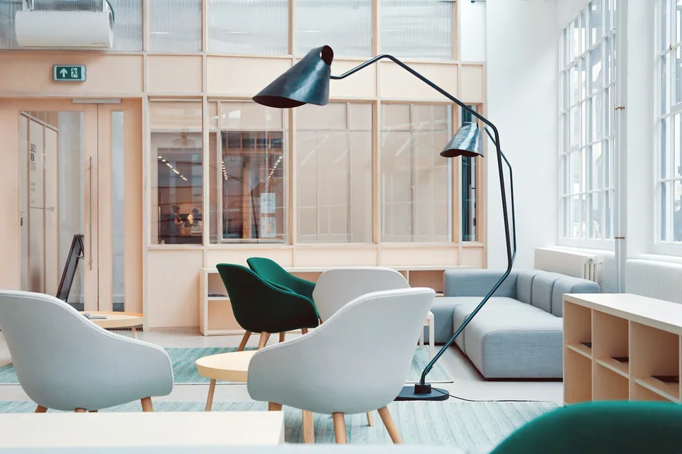 Bright lounge area with modern chairs and a floor lamp