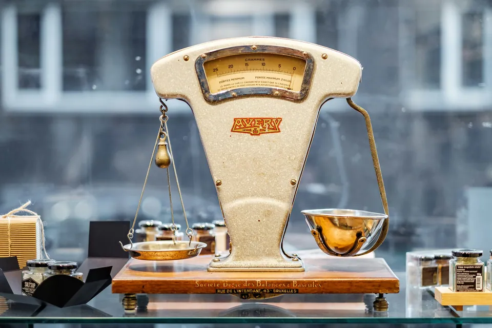 Vintage cream-colored weighing scale on a shop counter