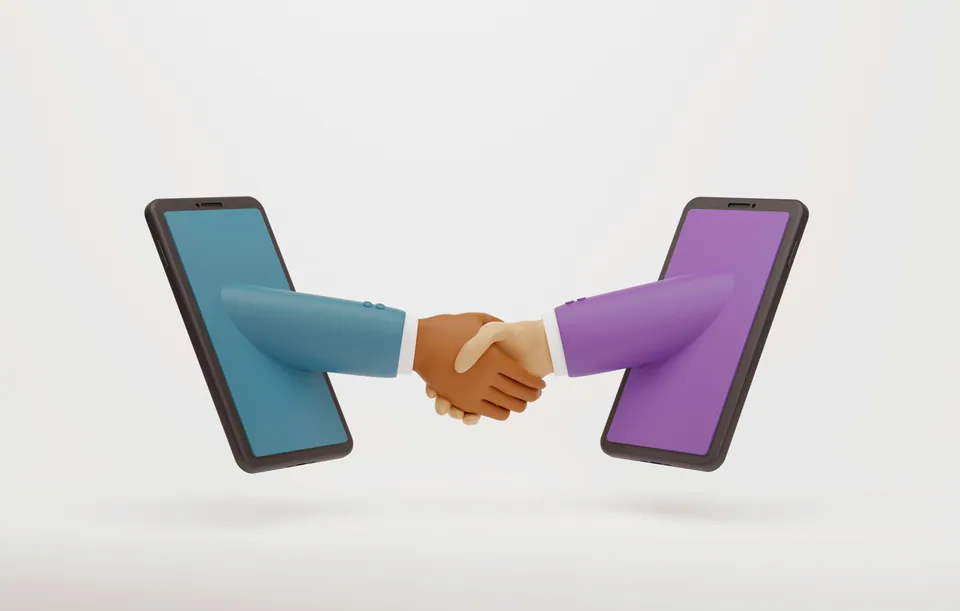 Two hands shaking from inside two smartphones