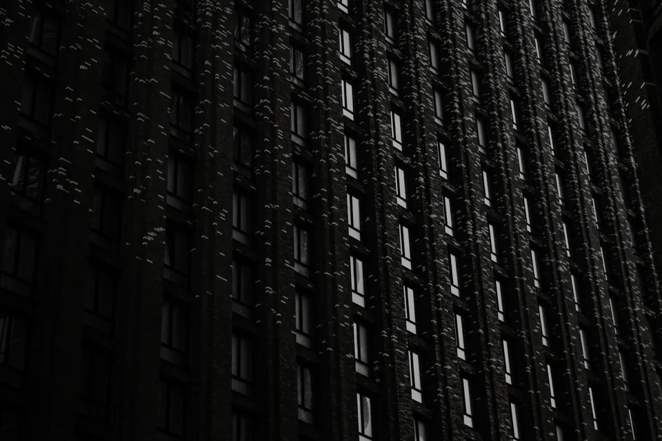 Lit windows on a dark high-rise building