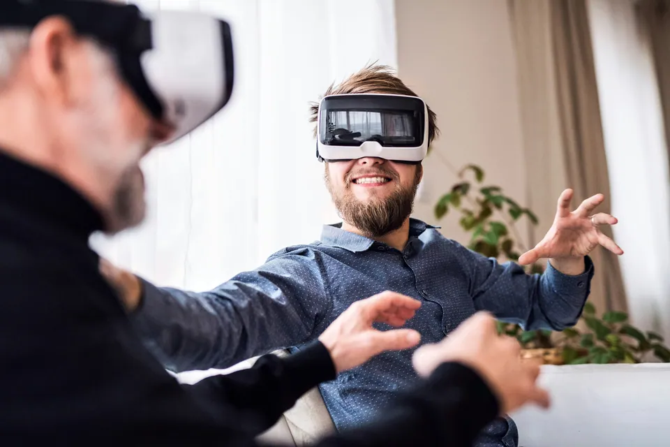 Two men wearing VR headsets gesturing in the air