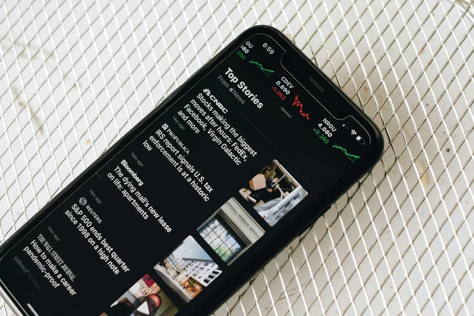 Smartphone showing financial news headlines