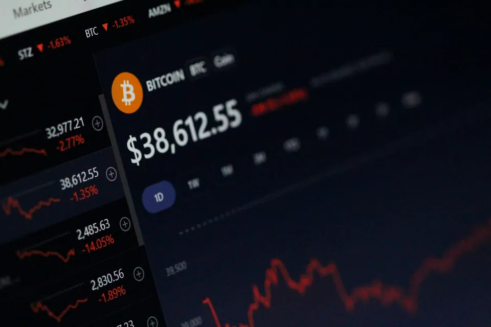Bitcoin price and crypto tickers on a dark trading screen