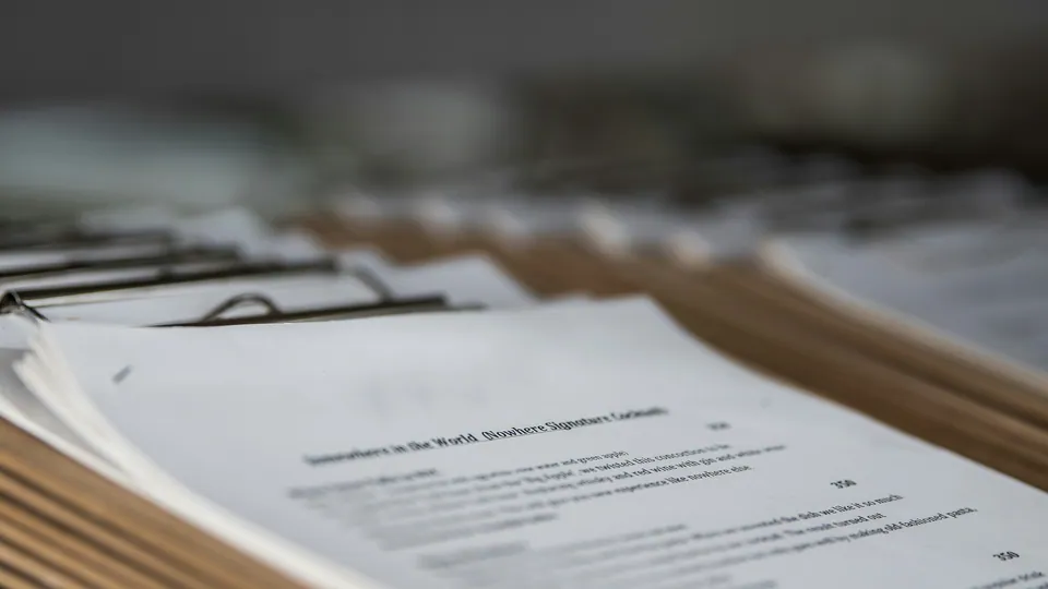 Stack of printed documents on clipboards