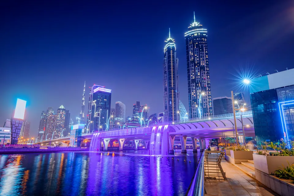 Dubai skyline lit up at night beside a canal