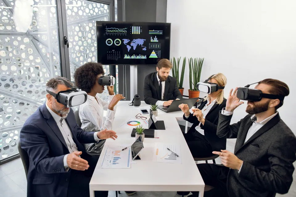 Business team wearing VR headsets at a conference table