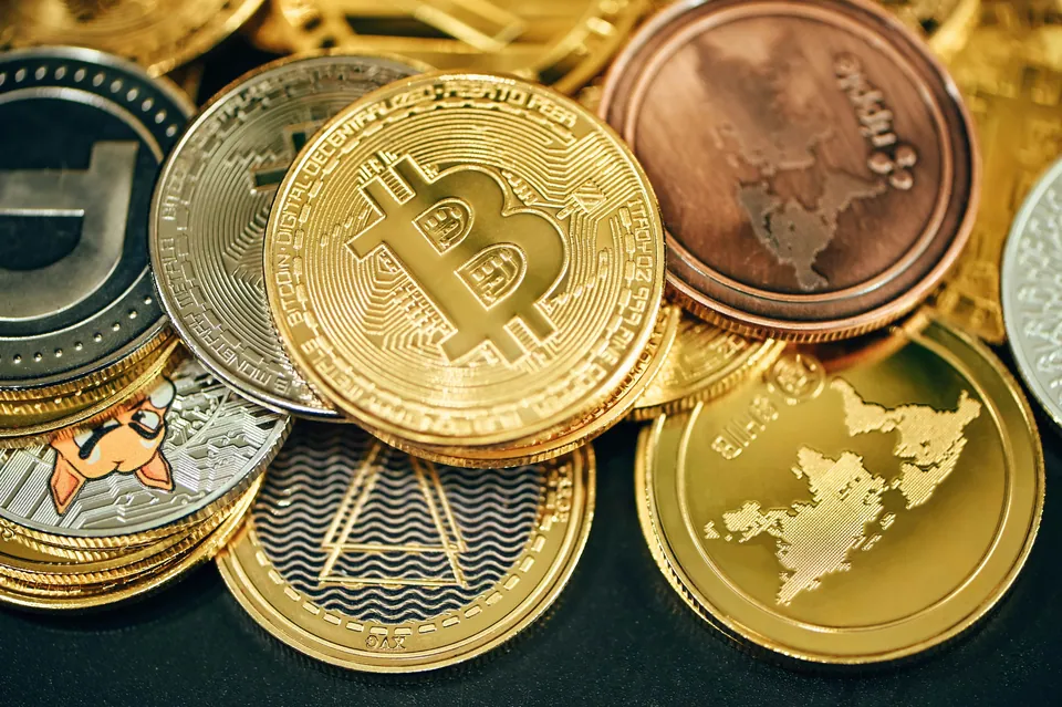 Pile of gold Bitcoin and other cryptocurrency coins