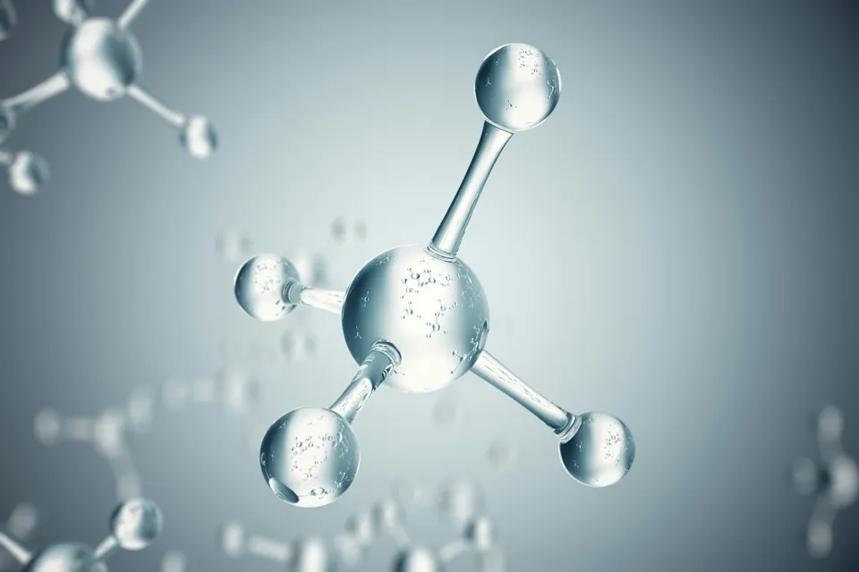 3D glass molecule model on a pale blue background