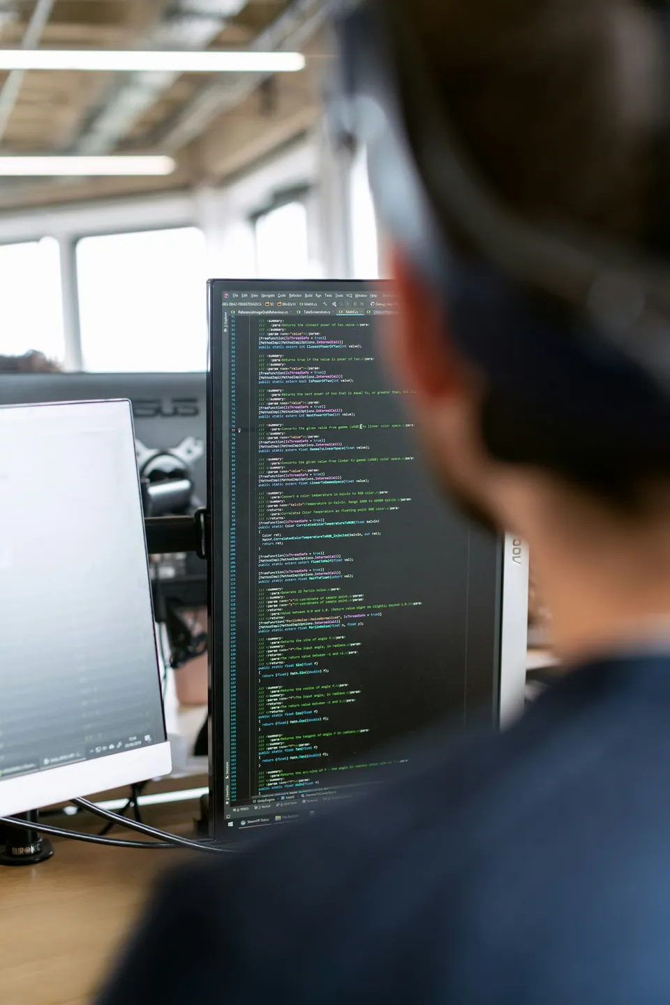 Developer looking at code on a monitor