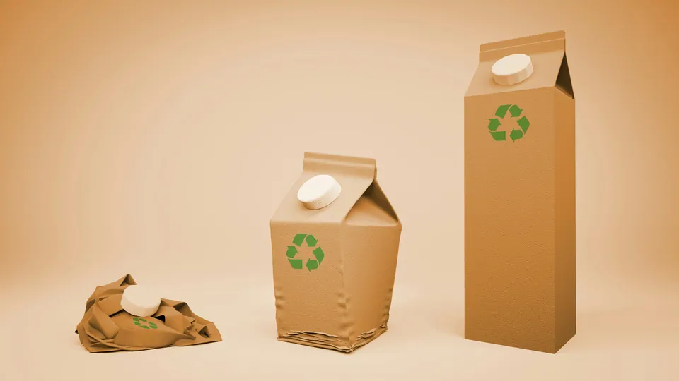 Recyclable cardboard drink cartons on a tan background