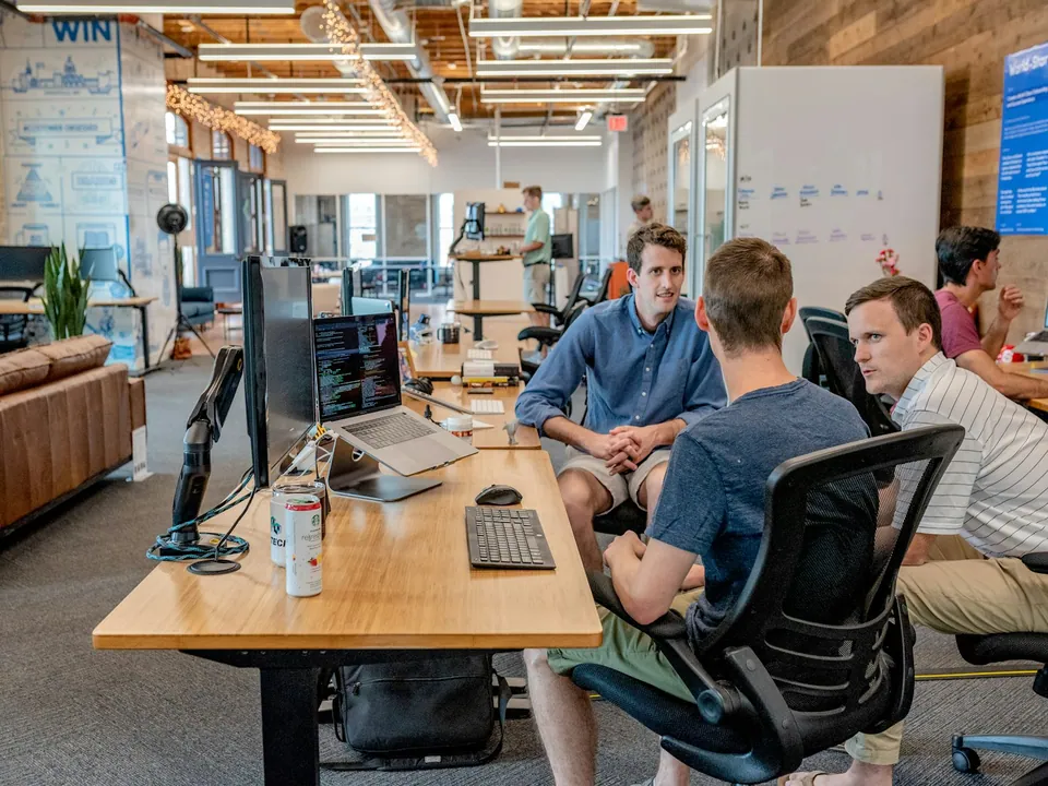 Team working at long desks in an open-plan startup office