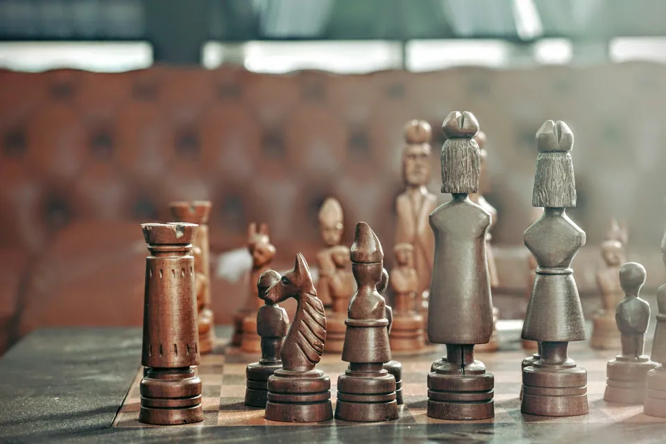 Carved wooden chess pieces on a board