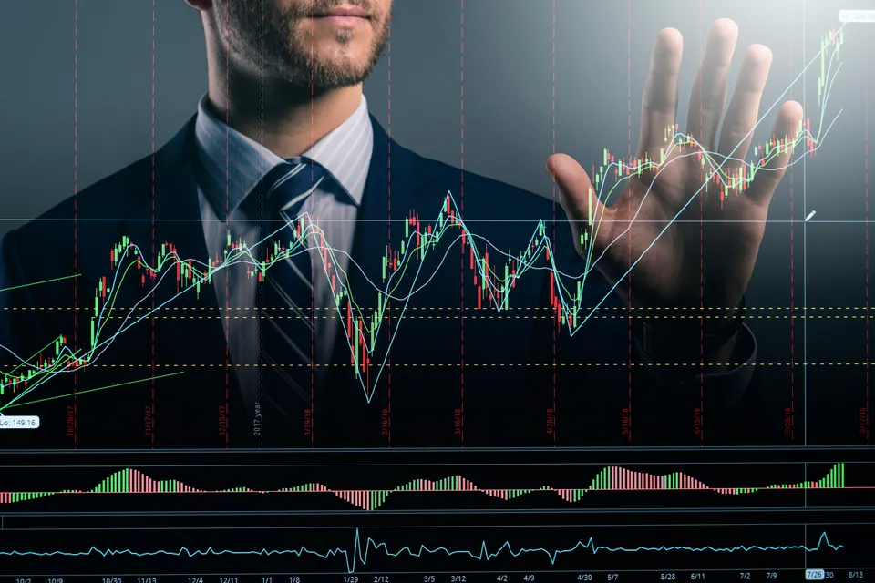 Businessman behind a transparent stock chart overlay
